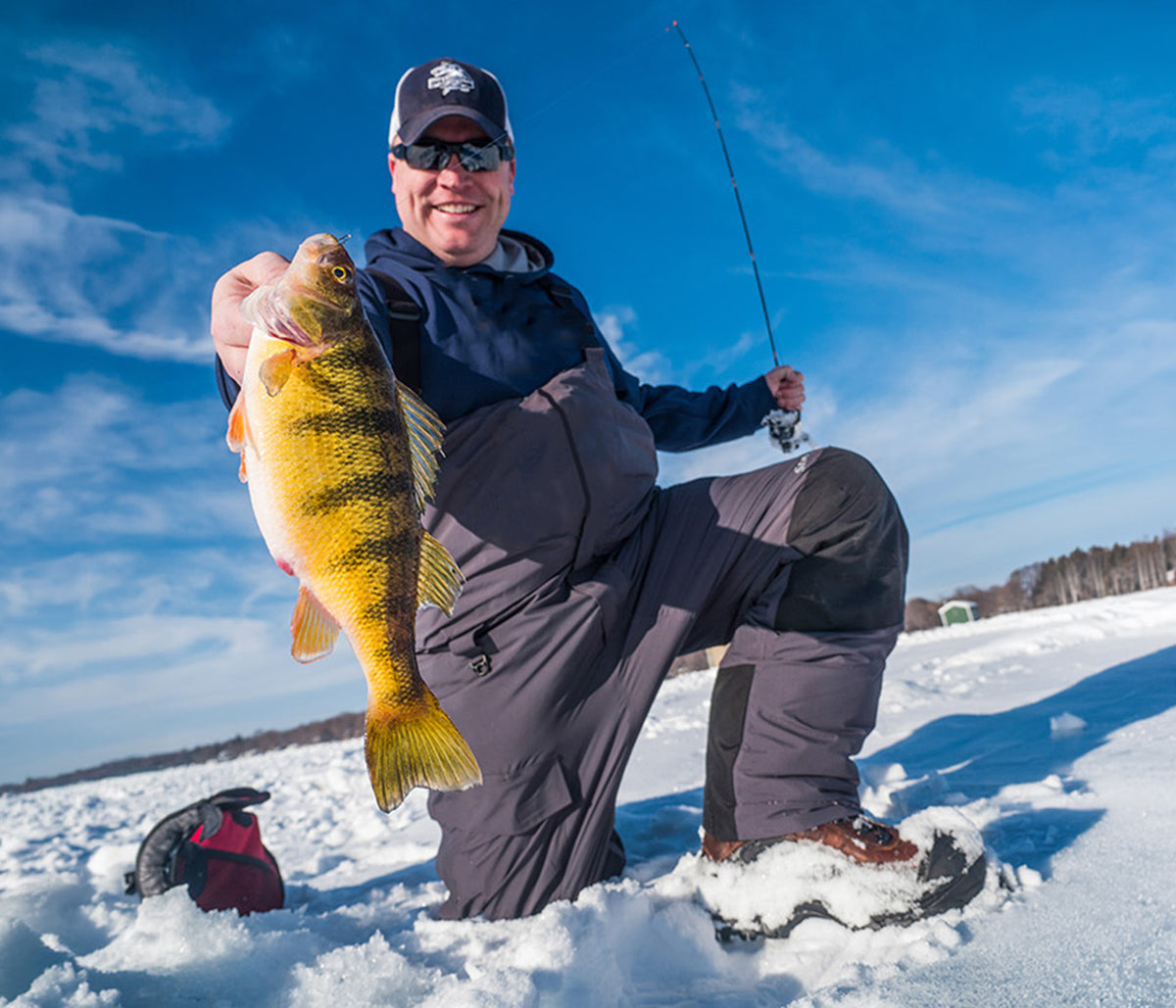 FishDaddy angler holding a jumbo perch while ice fishing in Minnesota